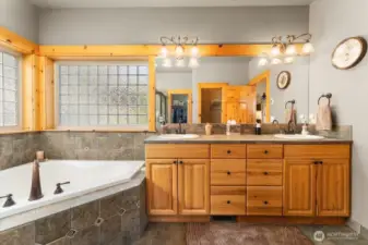 Dual sinks and vanities in the primary bathroom.