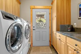 Laundry room with ample storage on the main floor. Door to the back yard.