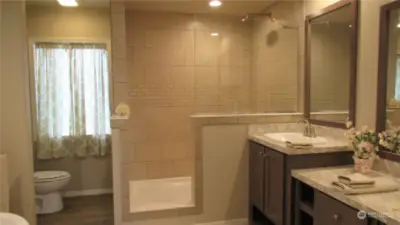 Primary Bathroom with double sinks and tiled walk in shower