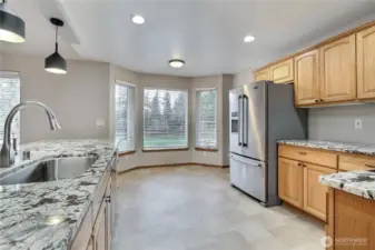 Beautiful granite counters on large dining peninsula.