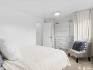 Spacious bedroom with custom closet organizer.
