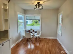 Dining area that is flooded with light from the 3 windows.