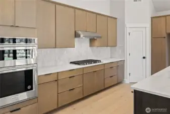 Quartz counter tops with full height backsplash.