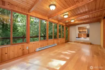 A massive sunroom facing the gorgeous territorial views is flooded with natural light. Through the pass through beyond you'll enter the clean, efficient kitchen space.