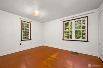 Largest of three bedrooms with vinyl windows, original wood flooring and a built-in closet.
