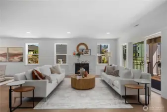 Great Room: Spacious great room with a modern tile-surround fireplace and large windows filling the room with light. The open floor plan connects to the kitchen and dining spaces, ideal for gatherings or relaxing evenings.  Staged photos are of the model home of the same floorplan within the Foxmoore community and are for visualization purposes only. Colors, finishes, and layout can and will vary.