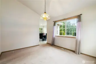 dinning room looking to the back yard and into the kitchen with eating area