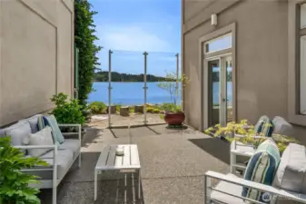 Patio area with storm glass to enjoy year-round outdoor use.  There are also gardens that are private to this home along with HOA covered general landscaping.