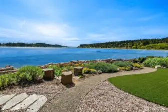 Outside the storm door on the patio is a private yard and natural-looking enforced bulkhead.