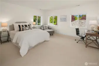 Upstairs garden bedroom with space for an office and sitting area.