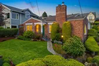 Desirable Magnolia home situated on a southwest facing corner lot with timeless curb appeal and a stunning arched window that floods the interior with natural light and captures Sound views.