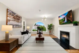 The formal living room offers a fireplace and south-facing Puget Sound views.
