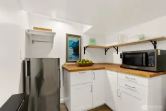 The lower level features a private guest suite with fourth bedroom, kitchenette, and ¾ bath, offering excellent separation of space.