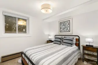 The lower level features a private guest suite with fourth bedroom, kitchenette, and ¾ bath, offering excellent separation of space.