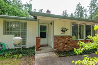 The front entryway, note the glass block wall which is the exterior wall to the guest bath.