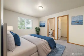Primary bedroom with a walk-in closet