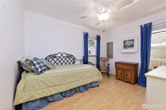 Guest bedroom with laminate flooring.