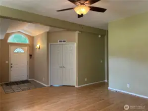 Front door.  Double doors are entrance to the den. Hallway leads to 2 bedrooms, hallway storage and a full bath.