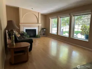 Formal living off front entrance.  Propane fireplace with heatilator provides heat if power is out.  Large picture windows provide everchanging views and so much natural light.  Flooring is UV protected laminate.