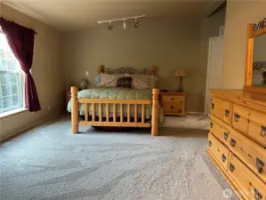 Primary bedroom with windows facing east.