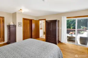 The primary suite has access to the deck and a newly refreshed bathroom