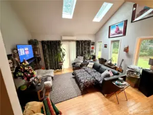 Living room with high ceilings and skylights.