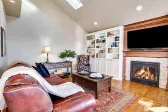Cozy family room features fireplace and built ins making a beautiful place to unwind.