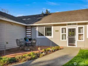 A new front yard features an 8’ deer-proof fence, sod lawn, paver patio, raised garden beds, and a welcoming sunroom entry—ideal for year-round enjoyment and gardening.