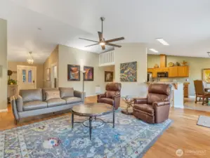 Large great room with vaulted ceilings and ample natural light.