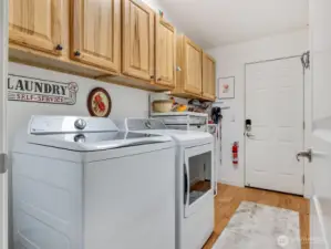 Laundry area leading out to an additional storage space and 2 car garage.
