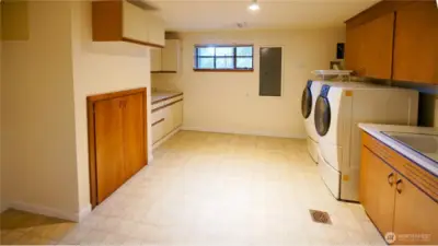 The utility room is on the lower level, and could possibly become a second kitchenette area.