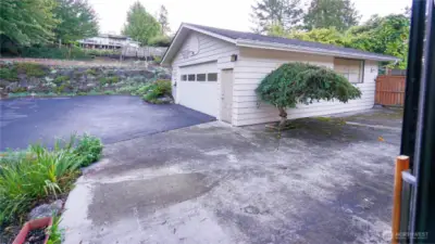 Garage, entertaining, and parking area as seen from the back door near the breakfast nook.