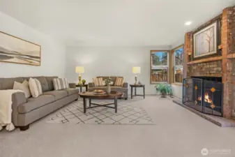 Family room with corner windows and brick fireplace