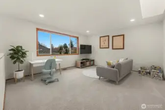 Second floor bonus room features skylight, new carpet and fresh paint. Could be ideal for a kids' play room, TV room, library, office or workout room.(digitally staged)