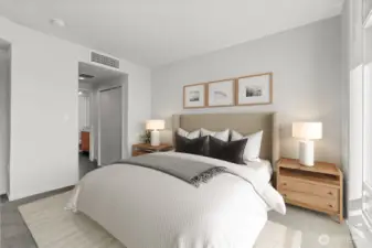 Primary bedroom w/ ensuite bath & own balcony (virtually staged)