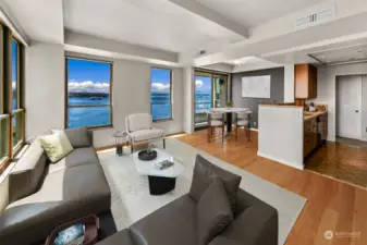 (Virtually staged & decorated) Showcasing sweeping views of Puget Sound from Rainier to the Olympics, live Seattle’s highlight reel from your light-infused, coveted SW corner residence at the Watermark Tower—a blank canvas awaiting your designer’s touch.