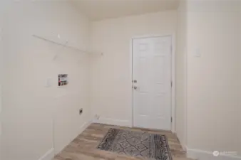 Spacious Laundry room with hookups, leading to back porch