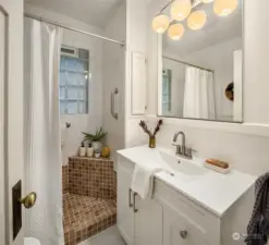 Stylish bath conveniently located between the two bedrooms.