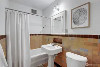 Full bathroom with tile, pedestal sink and new toilet.