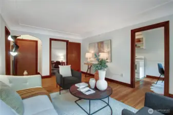 View from south windows toward front entry foyer, closet (used as office) and kitchen/dining entry.