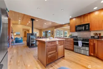 Kitchen, dining and living flow seamlessly together. Gorgeous soap stone woodstove adds ambiance and heat sink for the chilly winter days. Efficient forced air furnace with heat pump keeps the house evenly heated and warm! New dishwasher and garbage disposal in sink.