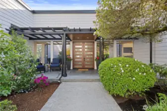 Popping with colorful flowers and accented with landscape lighting, you'll enjoy this courtyard entrance day or night.