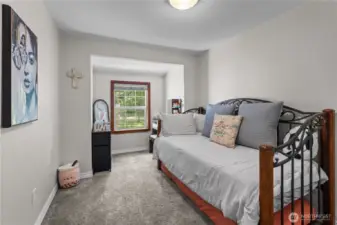 Charming Secondary Bedroom with Peaceful Garden Views  This cozy bedroom features plush carpeting, neutral walls, & a picture-perfect window nook overlooking the lush green landscape. Whether used as a guest room, nursery, or creative space, this room offers a peaceful retreat with plenty of natural light. Decorative touches & versatile layout make it both functional & inviting—perfect for anyone looking for comfort in the heart of nature.