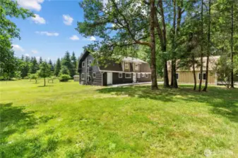 This isn't just a backyard — it's a private park. Surrounded by towering evergreens, this flat, usable land is perfect for gardening, outdoor gatherings, and peaceful country living.