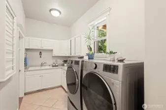 Even in the laundry room, this home features tasteful finishes and a polished, upscale aesthetic!