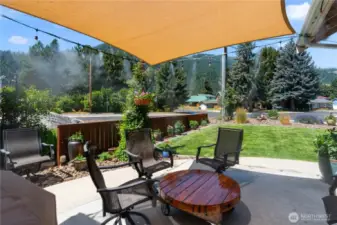Front patio area with misting system and shade sail.  Misting system and shade sail stay with house.