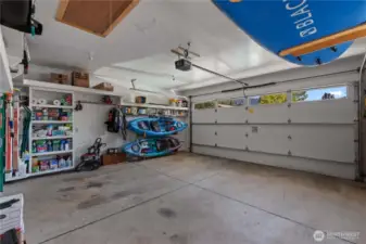 2 Car Garage Bay attached to house in addition to single car garage attached to house: Built in shelves, drop down ladder to attic storage. Climate controlled attic exhaust fan.  4 season living translates into extra gear and tools.  This property offers plenty of organized storage.