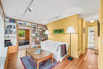 Built in bookshelves and window seating bring charm and function to this pretty living space.