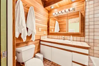 This cozy primary bath has warmth and style with the wood planking!