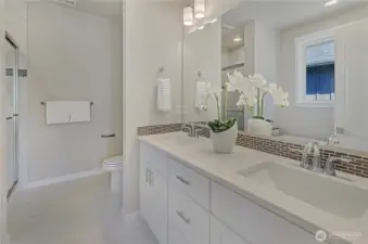A primary bath area with easy to clean, durable surfaces, ample cabinetry and storage, a large, tile surround shower plus a free standing bathtub.